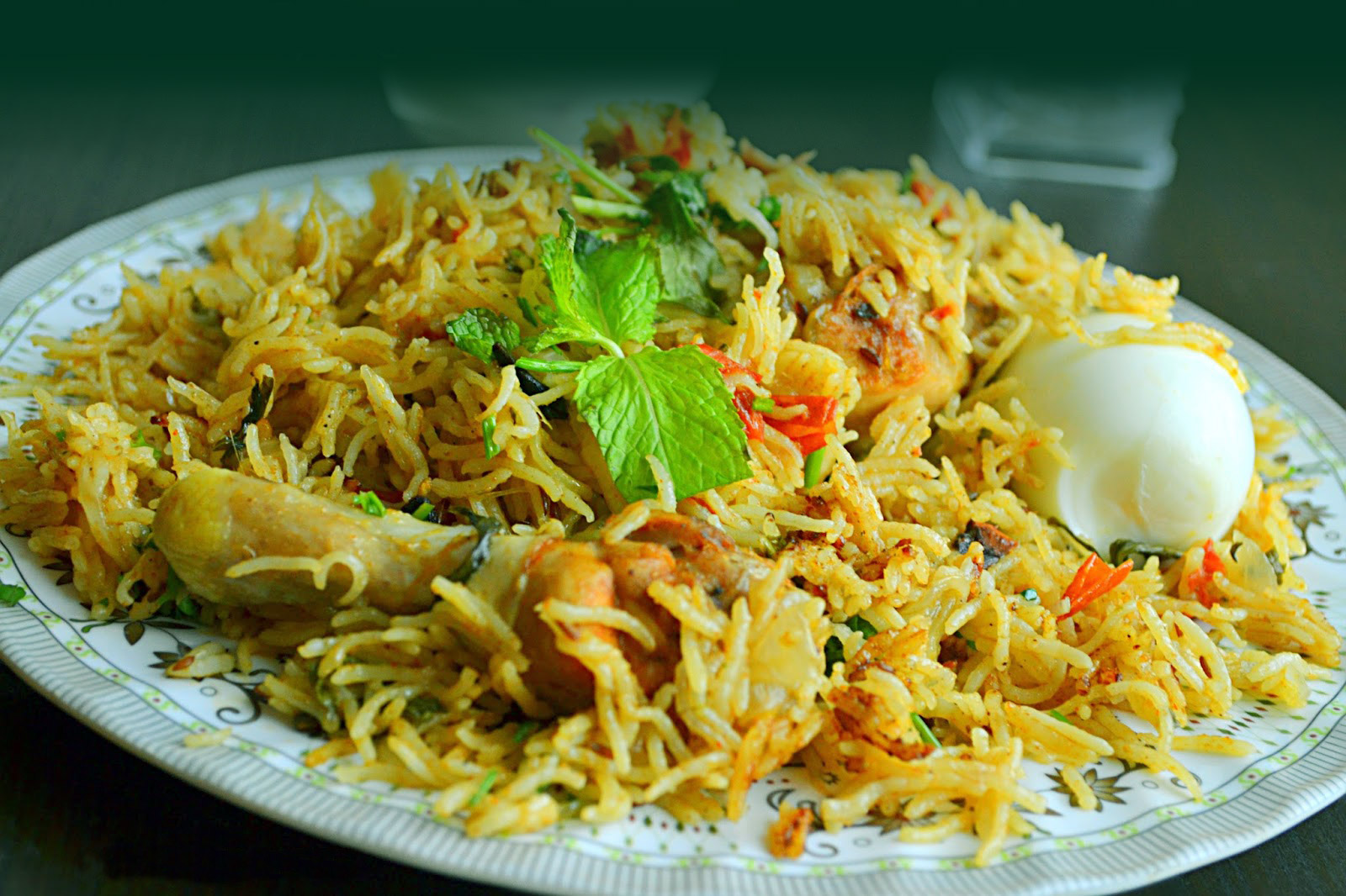 Delicious Chicken Biriyani in Plate topped with Egg